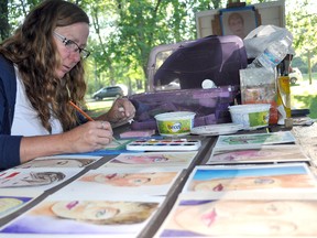 Lee Beaton works on a watercolour painting at Art in the Park Friday evening.  (CLARISE KLASSEN/PORTAGE DAILY GRAPHIC/QMI AGENCY)