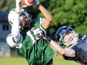 Chatham-Kent Cougars' D'wan Mailloux, left, makes a catch in front of Niagara Storm's Liam Bruch in the first quarter Saturday at the Chatham-Kent Community Athletic Complex. (MARK MALONE/The Daily News)