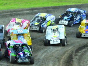 A large group of cars jockeys for position on turn four during the 358 Modified feature on Saturday night at Brockville Ontario Speedway. (STEVE PETTIBONE The Recorder and Times)