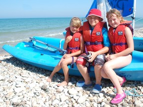 The Kincardine Yacht Club hosted the Ontario Sailing Association's BOOM (Best ever Ontario Optimist Mobile) mobile sailing school July 8-12, 2013. Participants learned basic sailing techniques and safety. L-R: Maddison Kelly, 7, Eric Hackney, 9 and Daniella McKitterick, 11, wait their turn to get out on the water. (ALANNA RICE/KINCARDINE NEWS)