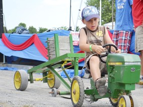 Gregory Harps works his way to the finish line in the kid's pedal tractor pull at the Avonmore Fair last summer. 
Kathryn Burnham staff file photo