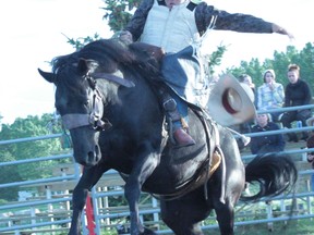 Alexandre Davingnon scored a 48 after this saddle bronc ride at the Nanton Nite Rodeo on July 13, 2013.