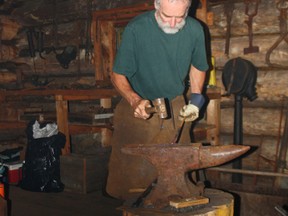 Blacksmith and farrier Bob Bartlett works a piece of metal in the smithy at Marten River Provincial Park during Lumberjack Day activities in 2012.