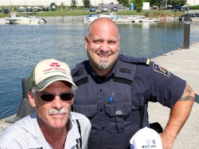 Jim Muir, president of the Kingston & District Fish & Game Club (left) with Kingston Penitentiary guard  Mike Deslauriers at the Portsmouth Olympic Harbour.
Ian MacAlpine The Whig-Standard