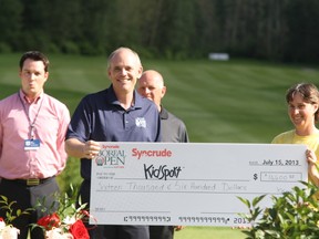 Syncrude president and CEO Scott Sullivan (L) with Leanne Patey of Kid Sport (R) at the Syncrude Boreal Open this weekend. ROBERT MURRAY/TODAY STAFF