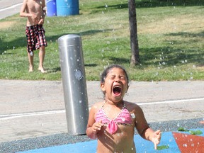 Amelia White, 4, cools off by running through water at a splash pad at Memorial Park in Sudbury, ON. on Monday, July 15, 2013. JOHN LAPPA/THE SUDBURY STAR/QMI AGENCY