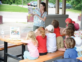 Pembroke Public Library summer student worker Rebeccah Sandrelli reads to children who made the trek to the Pembroke Farmer's Market for the regular Wednesday morning intalment of the library's summer Storytime program, which also meets in the library building on Tuesdays and Saturdays until the end of August.