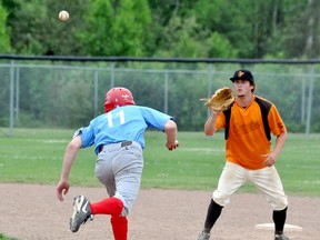 Orioles short stop James Daschuk reaches up to take a throw as Expos base runner Calvin Landriault dashes back to second base during a rundown play in the second inning of Monday’s Timmins Men’s Baseball League game at Fred Salvador Field. The Orioles rallied with two runs in the bottom of the seventh inning to post an 11-10 victory.