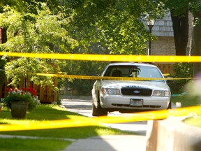 A townhouse complex on Old Burnhamthorpe Rd. is cordoned off after three family members were stabbed to death July 15, 2013. (CHRIS DOUCETTE/Toronto Sun)