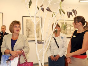 Alberta Culture Minister Heather Klimchuk checks out a needle-fetted tree piece on display at the Centre for Creative Arts, guided by executive director Candace Hook (right) and Grande Prairie artist Lynne LeCorre (centre). The minister visited some of the city’s top art and recreation facilities on Tuesday as part of the 2013 Culture Connects Tour. (Elizabeth McSheffrey/Daily Herald-Tribune)