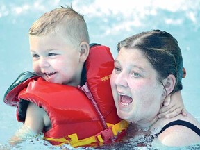 Happy swimmers including Kim Horton, with son Kaeden Lundrigan, 3, enjoyed a free public evening swim at Lions Pool in June. (SCOTT WISHART The Beacon Herald)