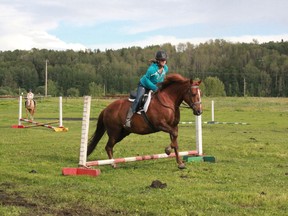 Jenna carter, 15, jumps her horse at the Poplar Ridge Riding School horse show on Thursday, July 11. The horse show gives the students an opportunity to show freinds and family what they have learned during their four days of lessons.
Celia Ste Croix | Whitecourt Star
