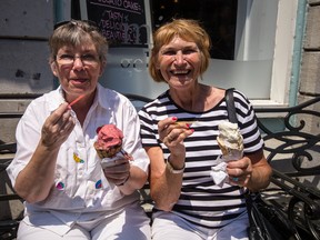 Pat Wilkinson of Kingston and Pat Gaul of Australia eat ice cream outside of Mio Gelato on Ontario street to stay cool in the heat. 
Sam Koebrich for The Whig-Standard
