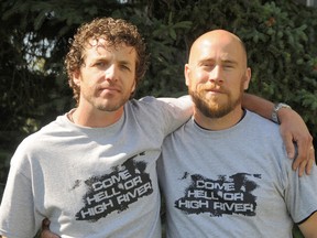 Aquatera communication workers Tim Conrad (left)  and Lloyd Piehl are back from a three-day flood relief trip in High River on Tuesday. Sporting their “Come Hell or High River” t-shirts, the pair say the experience will forever change them and the victims they assisted in the devastated town. (Elizabeth McSheffrey/Daily Herald-Tribune)
