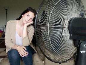 Stefanie Farrant sits in front of a fan as she cools off in her apartment in London on Tuesday. Farrant, who lives with her roommate on the fourth floor of a Platts Lane building, would like to see land lords who include heat in rent to also include air conditioning for the warmer months. CRAIG GLOVER The London Free Press / QMI AGENCY