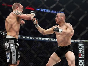 Réjean Groulx (long shorts, big tattoo on right shoulder) vs Mitch Gagnon (short shorts, small tattoo on left shoulder) during the Ringside 10 MMA gala  presented at the Bell Center in Montreal, Quebec, on April 9, 2011. PHILIPPE-OLIVIER CONTANT/QMI AGENCY