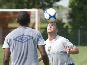 FC London coach Martin Painter heads a ball as he works with the team as they practise at Fanshawe College in London on Tuesday. (CRAIG GLOVER, The London Free Press)