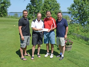 Former Pembroke Lumber King and alumni golf tournament organizer Pat Hahn, second from left, hands a $500 donation to Kirby Gallagher, nephew to the late Art Gallagher, in whose name a new bursary has been set up at Algonquin College for Lumber Kings players studying at the school. Joining Hahn and Gallagher were Lumber Kings’ owner and head coach Dale McTavish, left, and Algonquin College community and student affairs manager Jamie Bramburger.