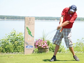 Jay Geddes takes a swing on the first hole of the Pembroke Golf Club during the annual Pembroke Lumber Kings Alumni Golf Tournament last Friday.