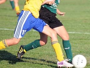 A Quinte West U12 Wolverine battles with a Cataraqui Clipper during Southeast Ontario Soccer Association action last Thursday at Centennial Park.