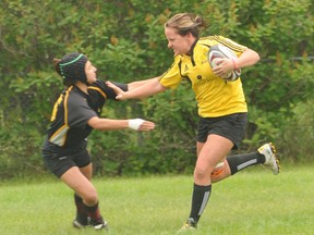 Grande Prairie Sirens captain Annie Jantz powers her way up field and throws off a tackle by an Leduc Crude West player for her first of three tries in an Edmonton Rugby Union Women’s Second Division match at Macklin Field Saturday. Crude West won 29-20. (Diana Rinne/Daily Herald-Tribune)