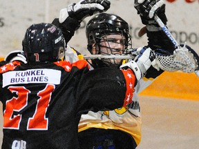 Norwood James Gang's Kyle Clancy is checked by Owen Sound North Stars' Zack Tomkinson during Ontario Lacrosse Association Senior B action at the Aspodel-Norwood Community Centre. Clancy has been drafted by the Durham Turfdogs of the CLax league. Clifford Skarstedt/Peterborough Examiner/QMI Agency file photo