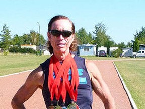 Joe Larsback on the Fairview High School track with the five medals he won at the Canada 55 Plus Summer Games in Cape Breton, N.S. (Aug. 29-Sept. 1) (CHRIS EAKIN/FAIRVIEW POST)