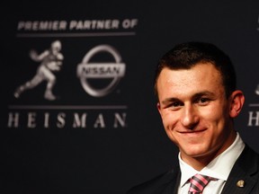 Texas A&M quarterback Johnny Manziel looks on during a news conference after winning the Heisman Trophy award in New York December 8, 2012. (REUTERS/Adam Hunger)
