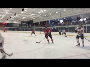 Quinn Gould (red jersey) competes in the Chicago Blackhawks prospect camp last week.  SUPPLIED PHOTO