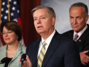 U.S. Senator Lindsey Graham (R-SC) and Senator Chuck Schumer (D-NY) (R) speak during a push for new bipartisan media shield legislation during a news conference at the U.S. Capitol in Washington, July 17, 2013. REUTERS/Jonathan Ernst