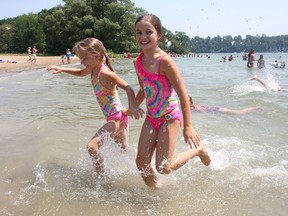 Emily Wintjes (left) 6 and her sister Jessica, 9, of Amherstview, enjoy the beach at Grass Creek Park. They were spending a hot Wednesday with their grandparents Josh and Rita Wintjes.
Ian MacAlpine The Whig-Standard