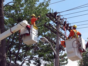 Wednesday's sizzling temperatures damaged hydro lines on Cromwell Street, near Forsyth, knocking out power in the downtown twice in the afternoon. Bluewater Power needed to make emergency repairs due to the potential for a fire, a spokesman said. Lineman Dan Duncan, left, and Dan Veenema were up in the bucket trucks restoring power to about 1,200 customers. CATHY DOBSON /THE OBSERVER/QMI AGENCY