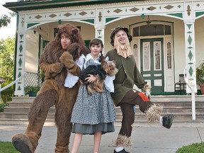 Kai Fox as the cowardly lion, Sarah Almeida as Dorothy and Ralph Tutin as the scarecrow march in front of the Bell Homestead on Wednesday as they rehearse for the Brant Theatre Workshop's production of The Wizard of Oz. (Brian Thompson, The Expositor)