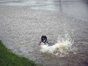 Anastasia Black swims in an overflowing ditch during the storm. She thoroughly enjoyed her temporary pool. For more community photos please visit our website photo gallery at www.thedailyobserver.ca.