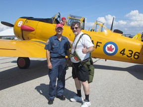 Fellow pilot Julian Glowacki, of Port Elgin, gives a big thumbs up after taking flight in on one of the vintage Harvards on display at the Kincardine Harvard Flights Airshow, Sat., July 6th at the Kincardine Airport. Piloting this aircraft is Scott McMaster with the help of attentive Crew Chief Shawn Wylie of the C.H.A.A. (JACQUIE TAYLOR/KINCARDINE NEWS FREELANCE)
