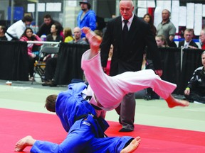 Colton Hall (Blue) scores a takedown to win an international judo competition.

Photo by Aaron Taylor/Fort Saskatchewan Record/QMI Agency