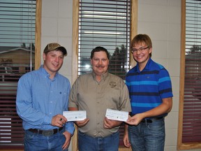 Rick Fletch, Whitecourt Fish and Game Association president presents Ryan McLauglin, (l) and Tyler Grierson (r) with two $1,000 scholarship cheques at the Whitecourt Star office on Wednesday, July 10.
Barry Kerton | Whitecourt Star