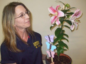 Wanda Paton admires a potted Mona Lisa lily in the MNP Exhibition Building during the recent Portage Industrial Exhibition on Island Park. It won second prize in class 544. (Ted Meseyton/Submitted Photo)