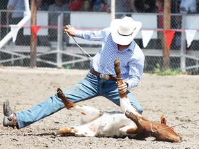 Chance Whittmore tying up a calf for the roping competition for the 2013 Buck Lake Rodeo on July 13.