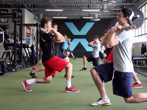 Pariticipants of the Abbot brothers' hockey camp do lunges with a weight bar Thursday at We Are Fitness in Point Edward. PAUL OWEN/THE OBSERVER/QMI AGENCY