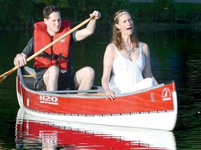 As Stratford Summer Music's James Beaver paddles the canoe, soprano Brooke Dufton sings an aria during rehearsal for R. Murray Schafer's Music for Wilderness Lake on the Avon River Thursday morning. (SCOTT WISHART The Beacon Herald)