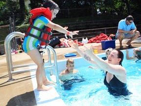 Abby Bacher, 4, and mom Vanessa cool off at the Lions Pool on Thursday during Oxford County's first heat wave of the summer.  (CODI WILSON/Sentinel-Review)