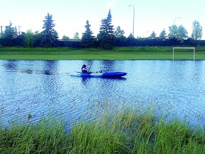 A kayaker takes a leisurely paddle through a pond in a park off Baseline Road following Monday’s heavy rainfall. Photo Courtesy Pauline Freeman