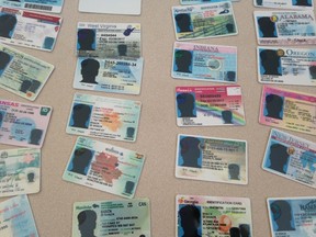 Toronto Police displayed hundreds of fake IDs seized in a raid Tuesday. (ANGELA HENNESSEY/Toronto Sun)