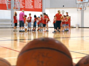 Instructor Austin Mueller shares basketball tips and tricks with campers at the Grande Prairie Regional College (GPRC) gymnasium on Monday. Young sport enthusiasts have the opportunity to explore a variety of athletic activities offered in the Multi Sport program. (Caryn Ceolin/Daily Herald-Tribune)