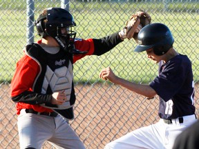 A Dodgers’ player beats the tag at home plate at Mitford diamonds July 12, 2013, a game that saw the Cochrane team hammer a Calgary team to go 2-0 on the season in the Calgary Baseball League.