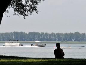 Don Leveille, of Wallaceburg, spends a leisurely afternoon under the shade of the willow trees at Mitchell's Bay while fishing with Jan VanBoven, not seen. The two men were taking it easy as temperatures climbed into the low 40s with the humidex.  Diana Martin/Chatham Daily News/QMI Agency