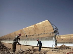 Workers construct a solar power plant in Morocco