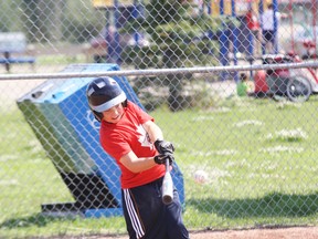 Cohan Sinclair of the Mosquito AA Oil Giants focuses on the ball during batting practice Thursday at Ron Morgan Park in Thickwood. The Oil Giants are hosting the Mosquito AA Tier III Provincial Championships this weekend.  ROBERT MURRAY/TODAY STAFF