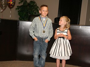 Mark Wierzbicki/QMI Agency
Denay Seeley looks up at Brandon Irwin, who saved her life after he swam into the Pembina River to stop her from being swept away earlier this month. Irwin was presented with a medal for an Act of Bravery in Calmar on Thursday, July 11.